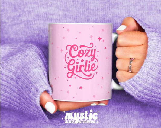 Pink Cozy Girlie coffee mug with stars, held in hands wearing a lavender sweater.